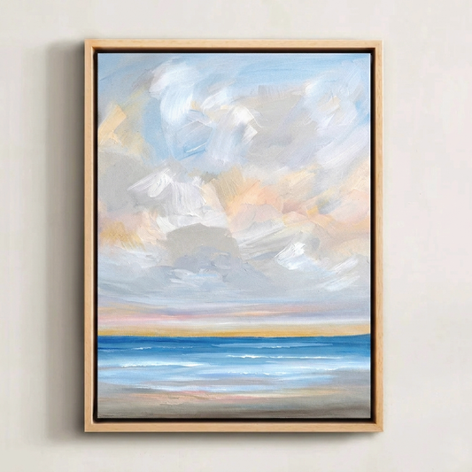 Coastal Art. Framed, peaceful abstract ocean painting of a calm sky and blue water on a white wall